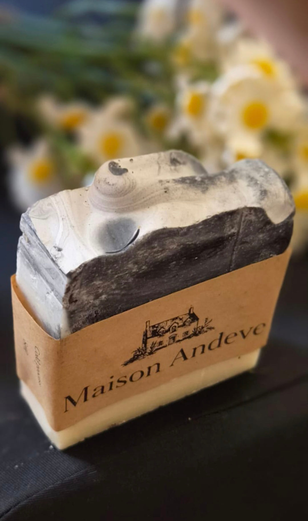 Maison Andeve handmade activated charcoal soap with black and white swirled top and kraft paper band