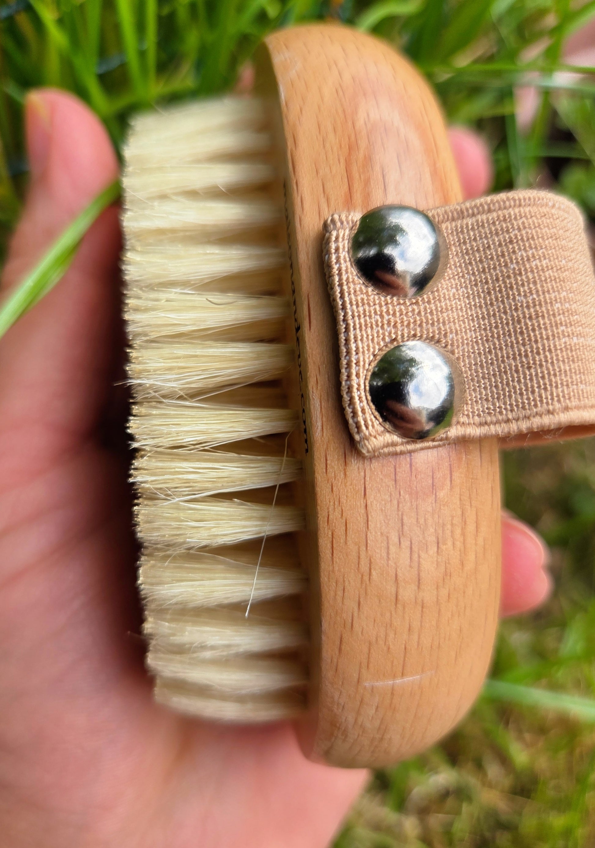 Side view of Maison Andeve wooden dry brush showing natural bristles and strap, used for lymphatic drainage and exfoliation