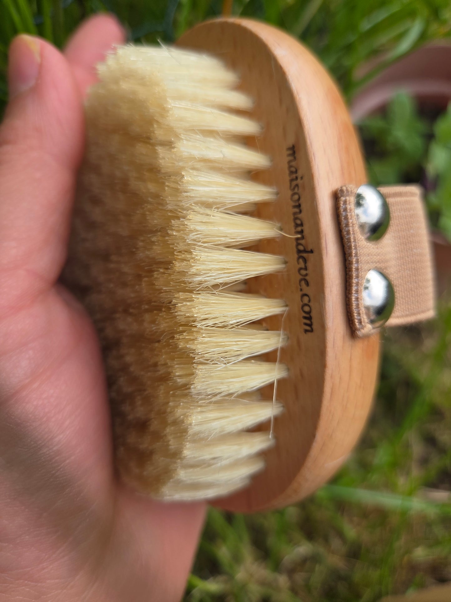 Side view of Maison Andeve wooden dry brush showing natural bristles and hand strap for exfoliating skincare