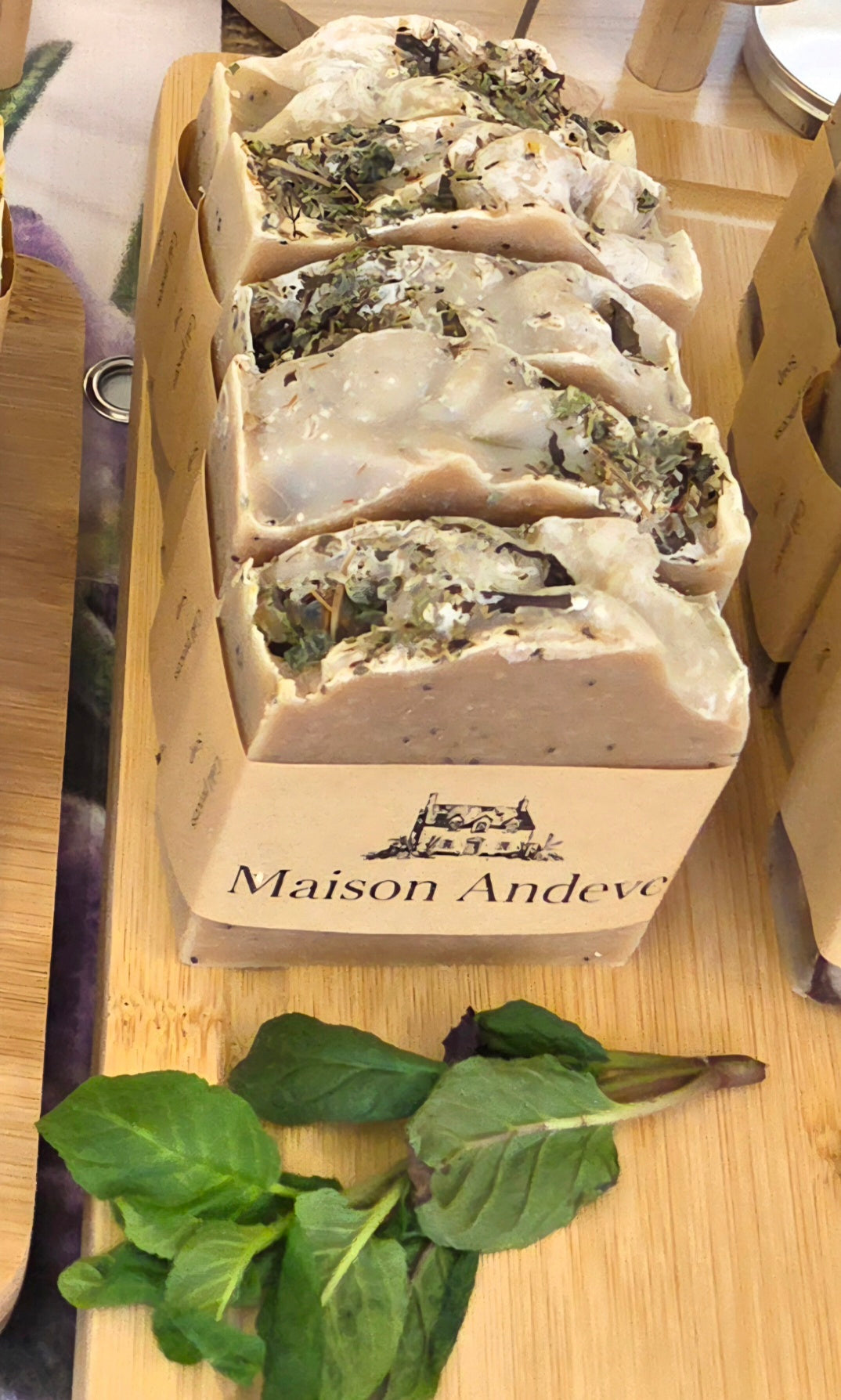 Maison Andeve handmade herbal soap loaf with natural ingredients and botanical texture on wooden display