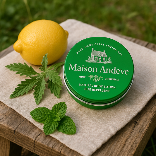 Maison Andeve mint and citronella lotion bar tin outdoors with lemon, mint leaves and greenery.